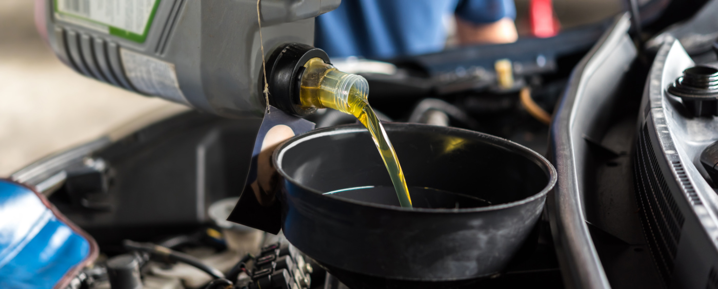 Mechanic pouring engine oil into a vehicle - Car Servicing Colwick, Nottingham
